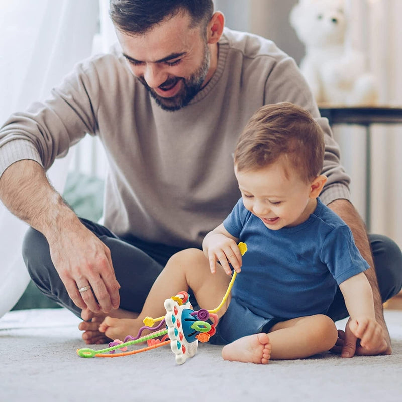 Ufo Bloom – Juguete clásico para bebés en forma de un OVNI con cuerdas para tirar y botones laterales táctiles