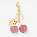 Llave de metal con colgante de cereza