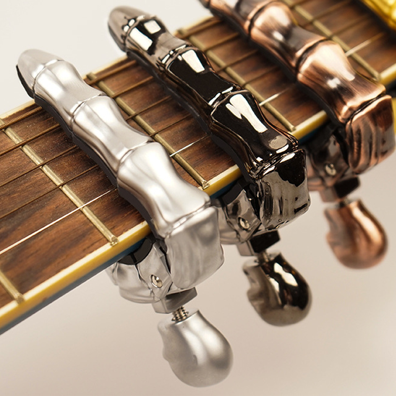 Capo de Guitarra en Forma de Calavera - Juguetes y Regalos